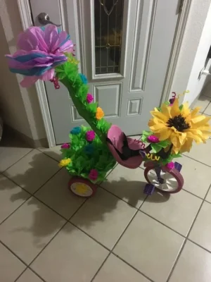 Adornar triciclo primavera con flores y hojas de papel grandes